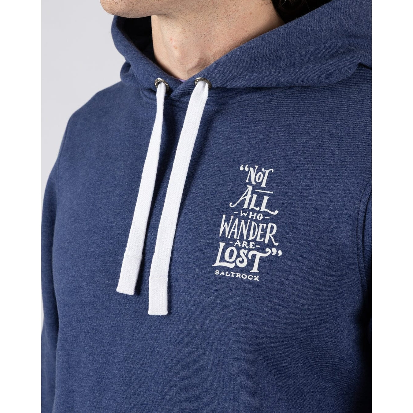 Close-up view of a men's Saltrock Lost Ships pop hoodie in blue featuring a print of the quote "Not all who Wander are Lost"