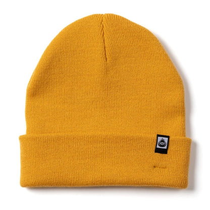 Front view of a yellow Saltrock Ok beanie with a turn back hem and a small logo on a white background