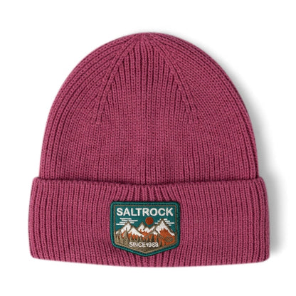 Front view of a Dark Pink Saltrock knitted beanie with turn-up hem and mountains logo patch on a white background