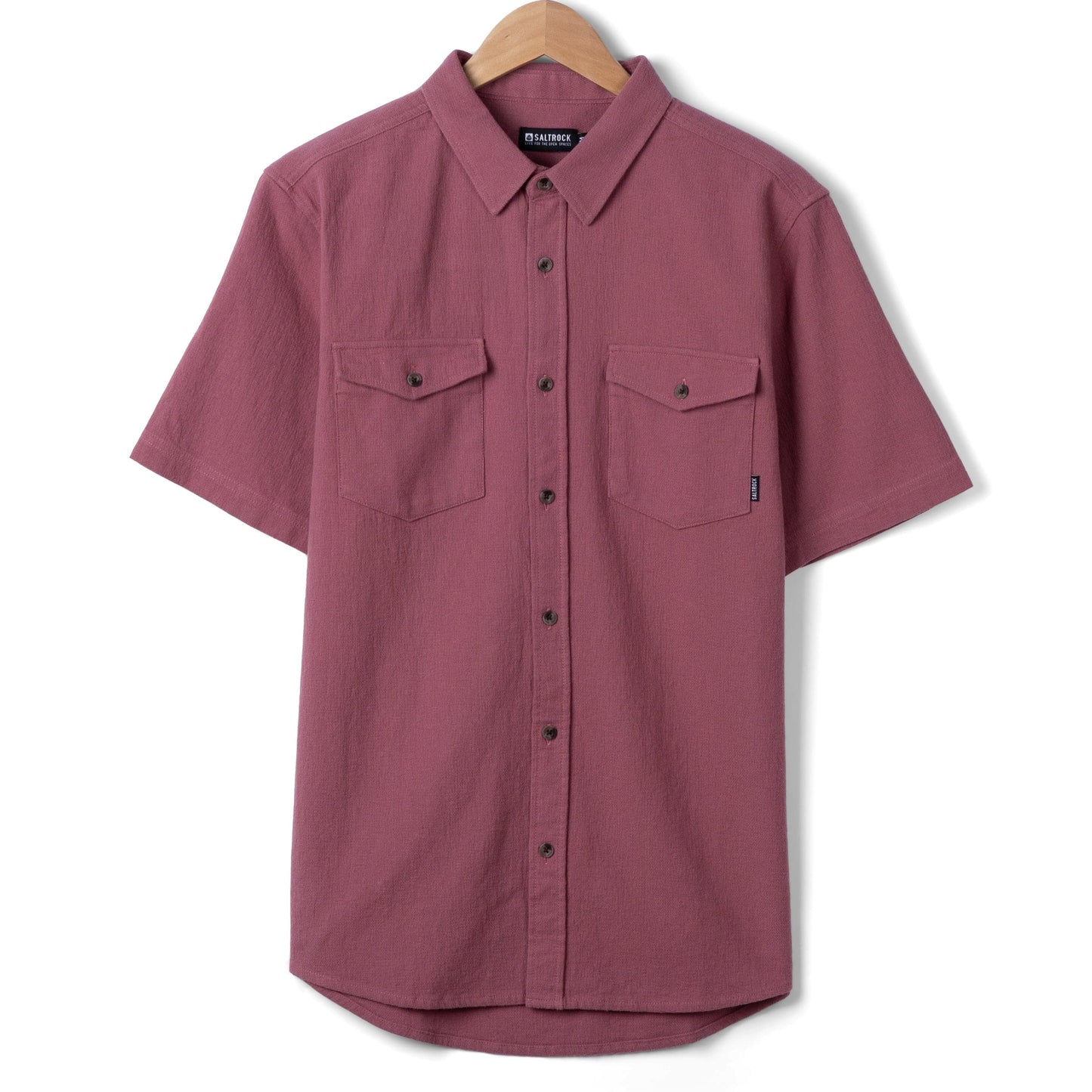 Front view of a Saltrock mens short sleeve Polperro shirt in dark pink with button through front and two button pockets on the chest with small logo on one pocket.