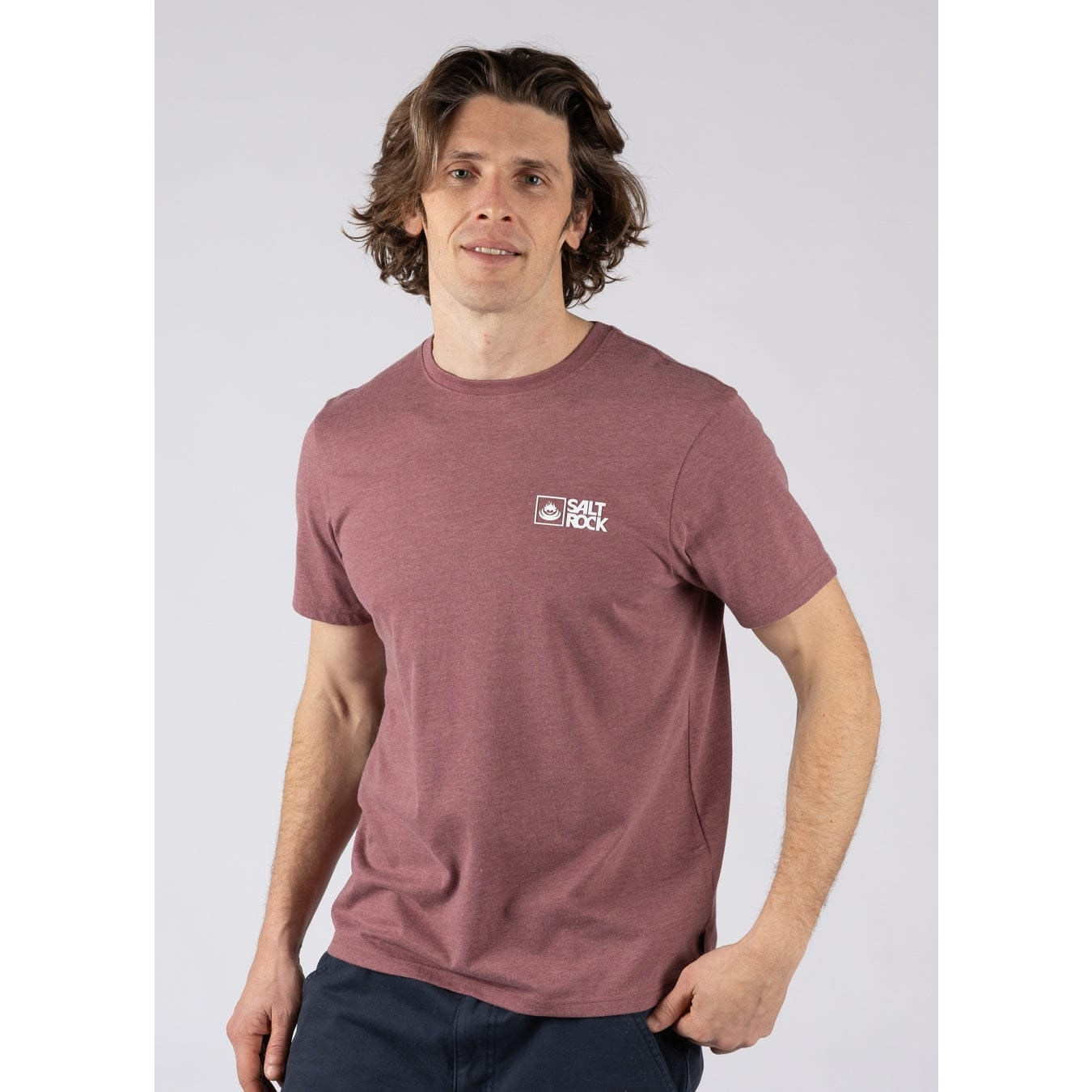 Front view of a man wearing a Saltrock short sleeve Essential crew neck t-shirt in dark pink with a small logo on the chest