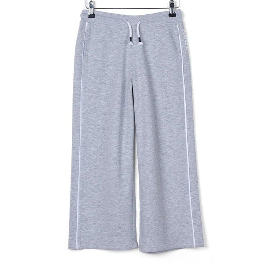 Front view of kids Saltrock Tok Corp jogger trousers in grey with elasticated drawstring waist with white piping down the side of the legs.