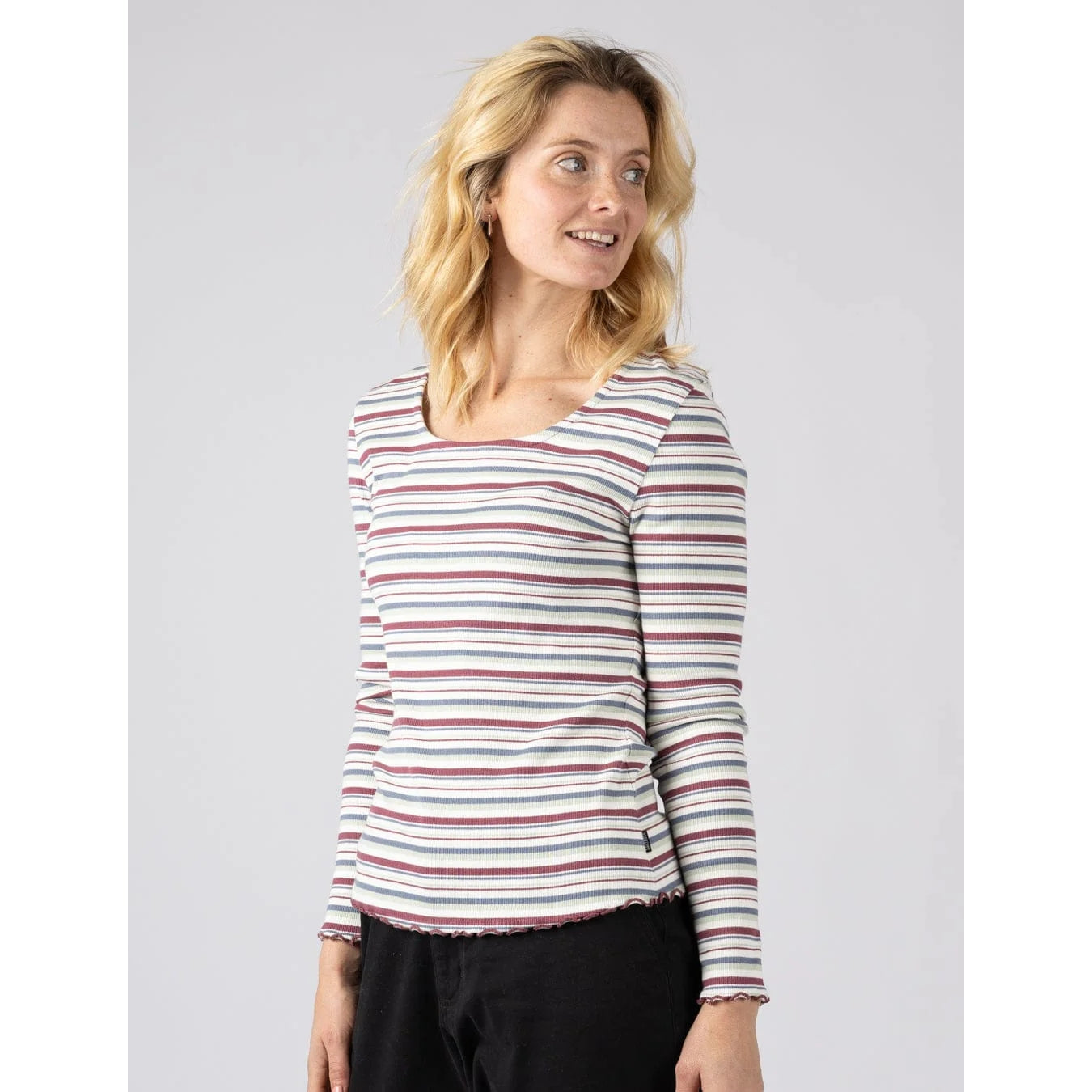 Front view of a woman wearing a Saltrock long sleeve Lenna t-shirt in white with a multicolour stripe pattern