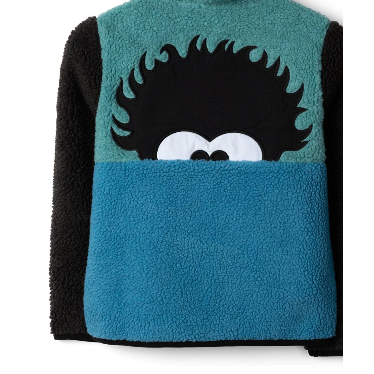 Close-up view of the back of a kids Saltrock Tok Emery colour block fleece in blue, black and teal with a black Tok character applique.
