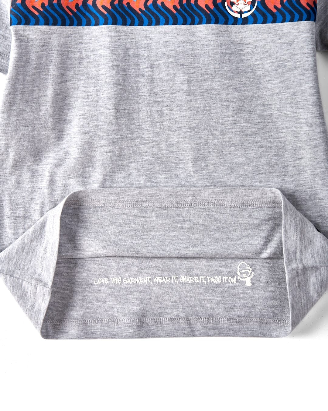 Saltrock kids grey stripe tee showing soft fabric and inner garment care label