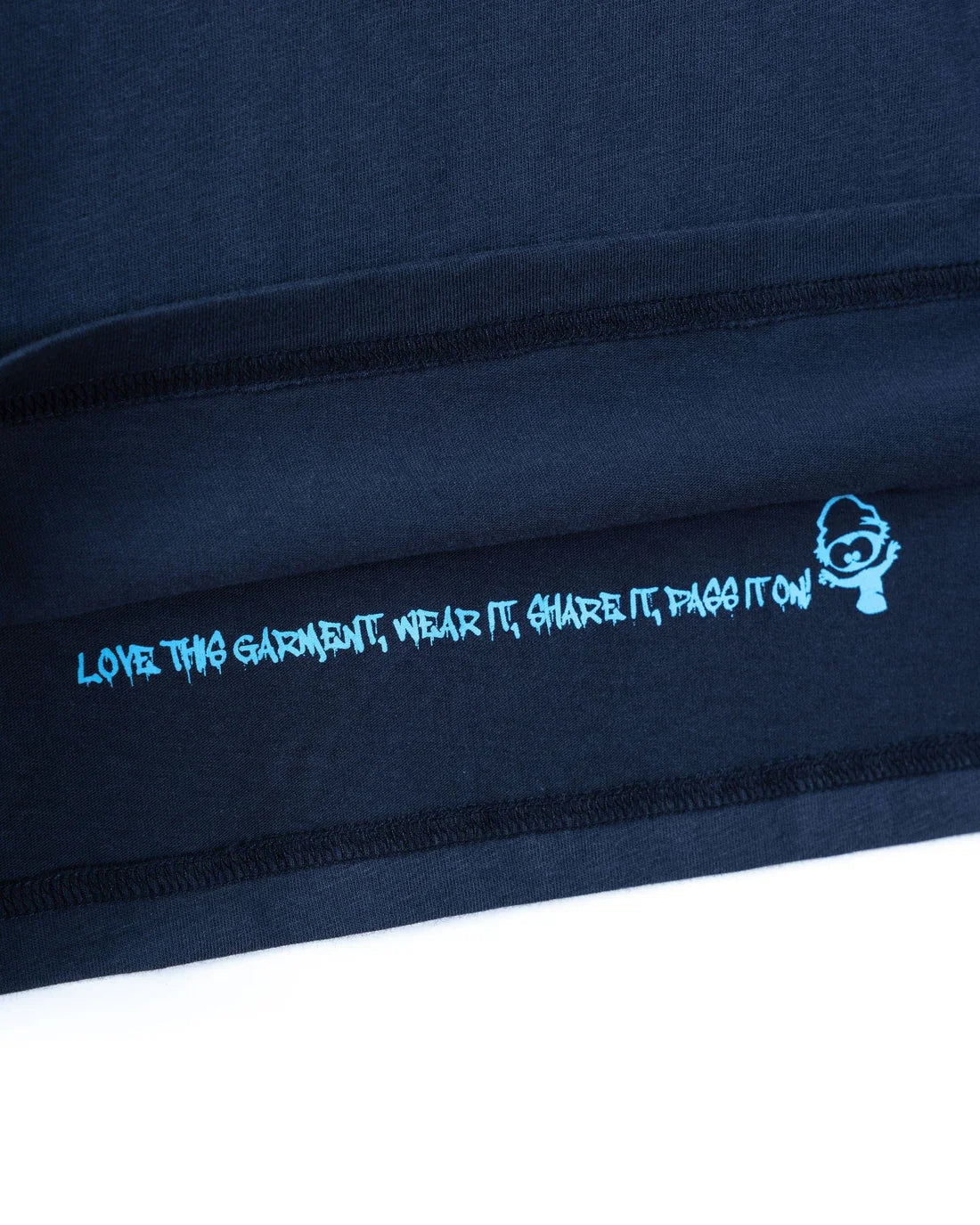 Close-up of blue Saltrock kids stripe tee blue with printed slogan on inner hem