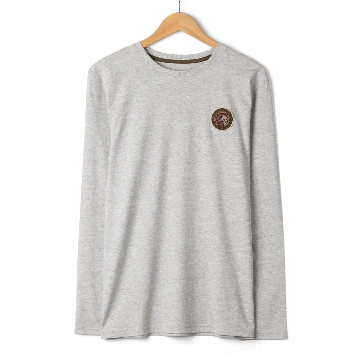 Front view of a mens Saltrock Trail Badge long sleeve t-shirt in grey with small circular patch logo badge featuring a skull