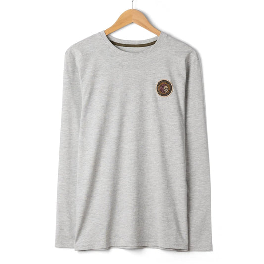 Front view of a mens Saltrock Trail Badge long sleeve t-shirt in grey with small circular patch logo badge featuring a skull