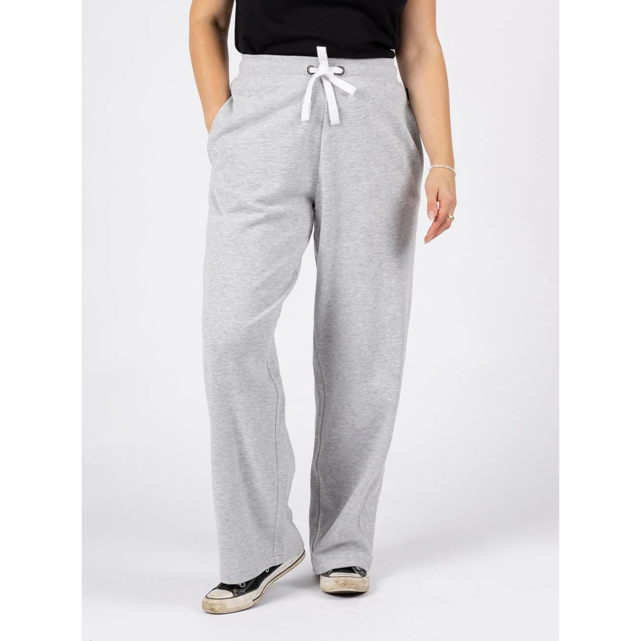 Front view of a woman wearing a pair of Saltrock sweat trousers in grey with drawstring waist.