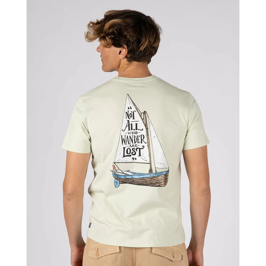Back view of a man wearing a Saltrock short sleeve Lost Ships t-shirt in light green featuring a sail boat print with the phrase "Not all who Wander are Lost"