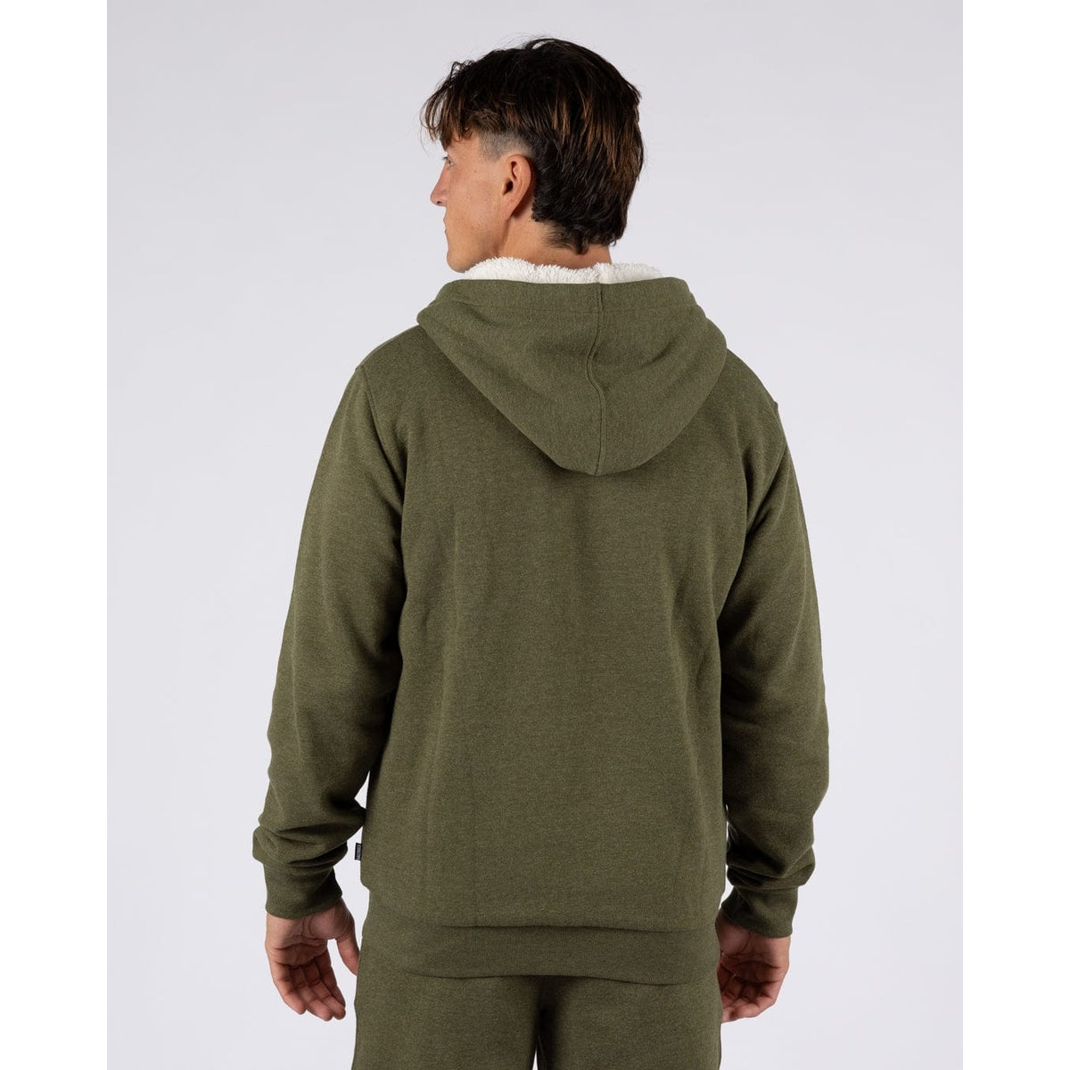 Back view of a man wearing a Saltrock Essential full zip faux fur lined hoodie in khaki green.