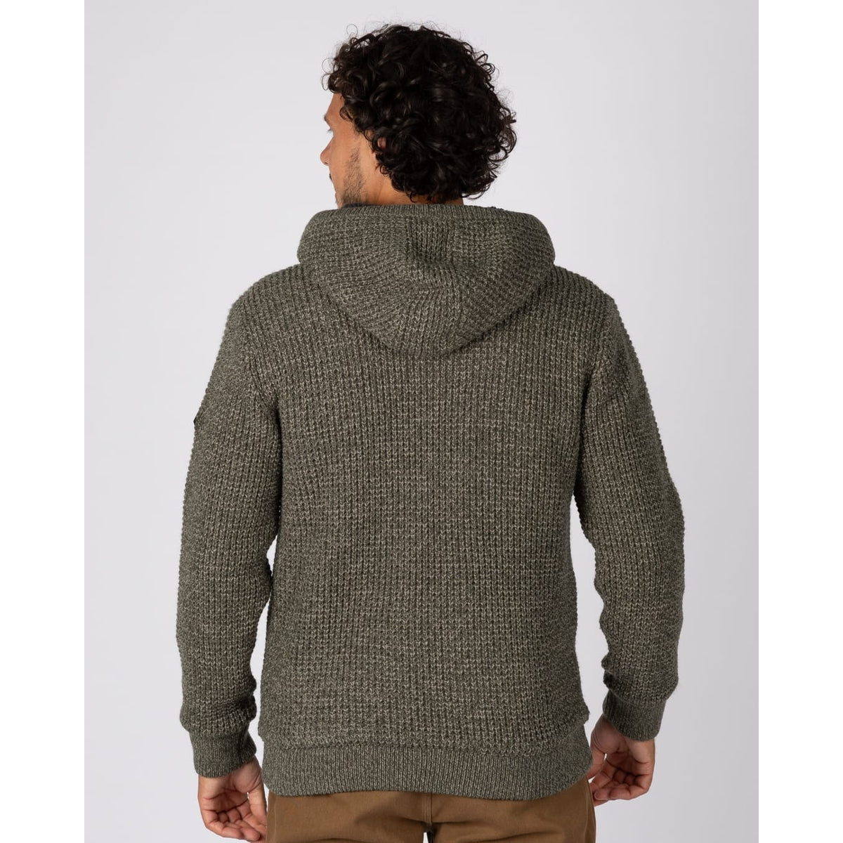 Back view of a man wearing a Saltrock dark green Markus knitted hoodie with a fluffy navy Borg lining.
