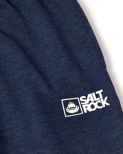 Close up of a white Saltrock logo on a pair of mens blue marl Saltrock jogger sweat trousers on a white background