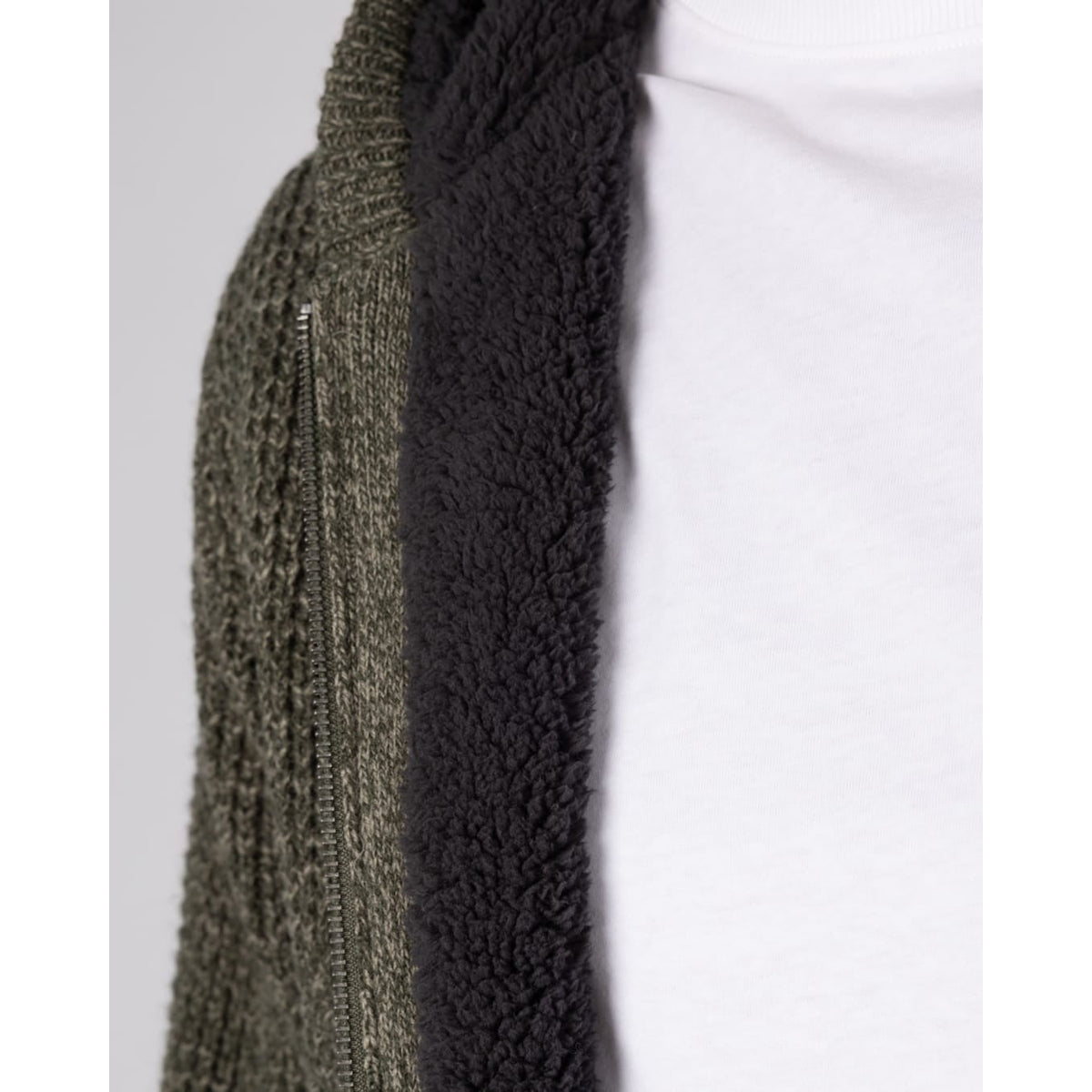 Close-up view of the navy Borg lining of a Saltrock dark green Markus knitted zip hoodie.