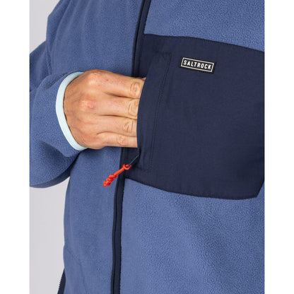 Close-up view of the navy chest zip pocket on a Saltrock full zip Leo fleece in blue.