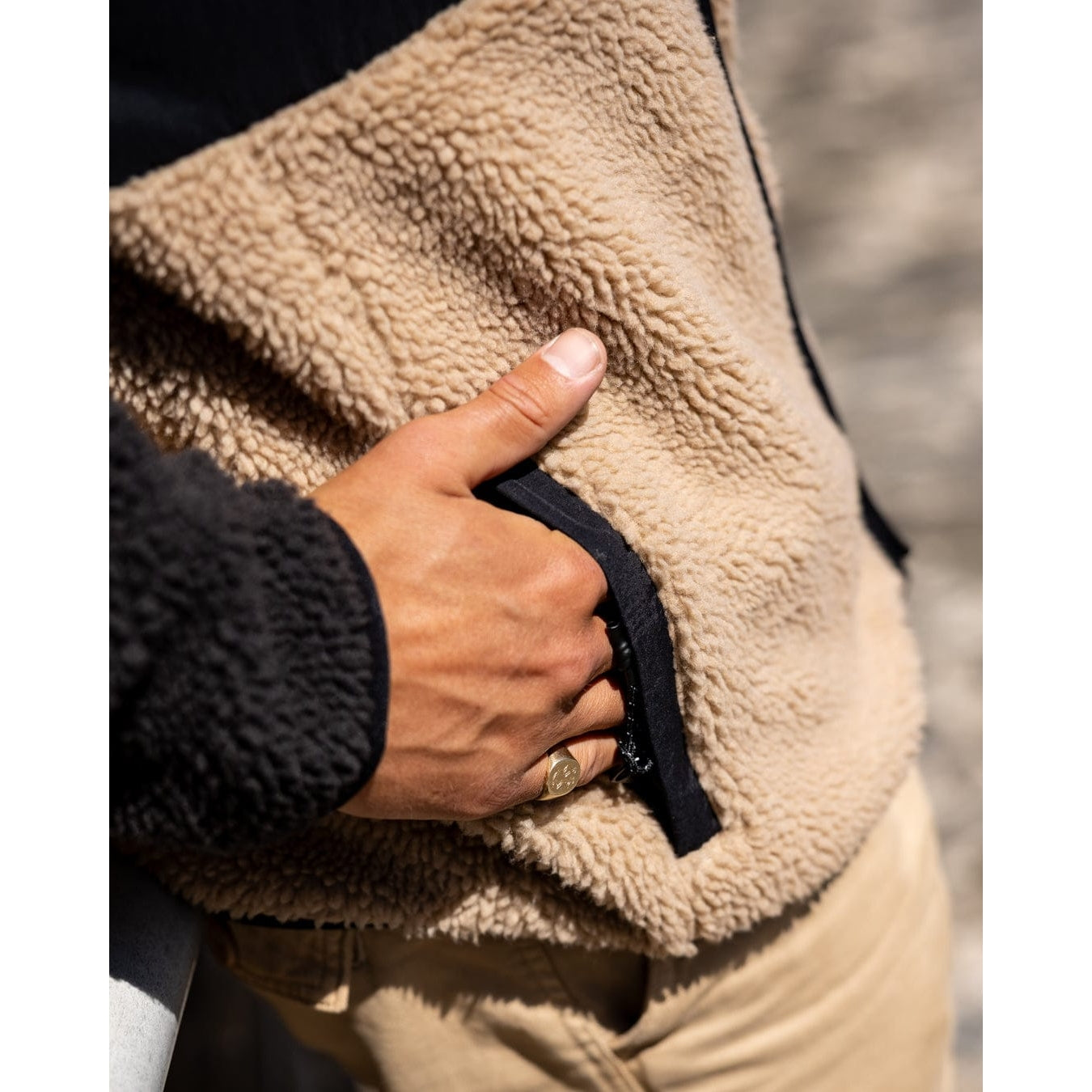 Close-up view of the zip pocket of a men's Saltrock Rafe zip fleece in black and beige