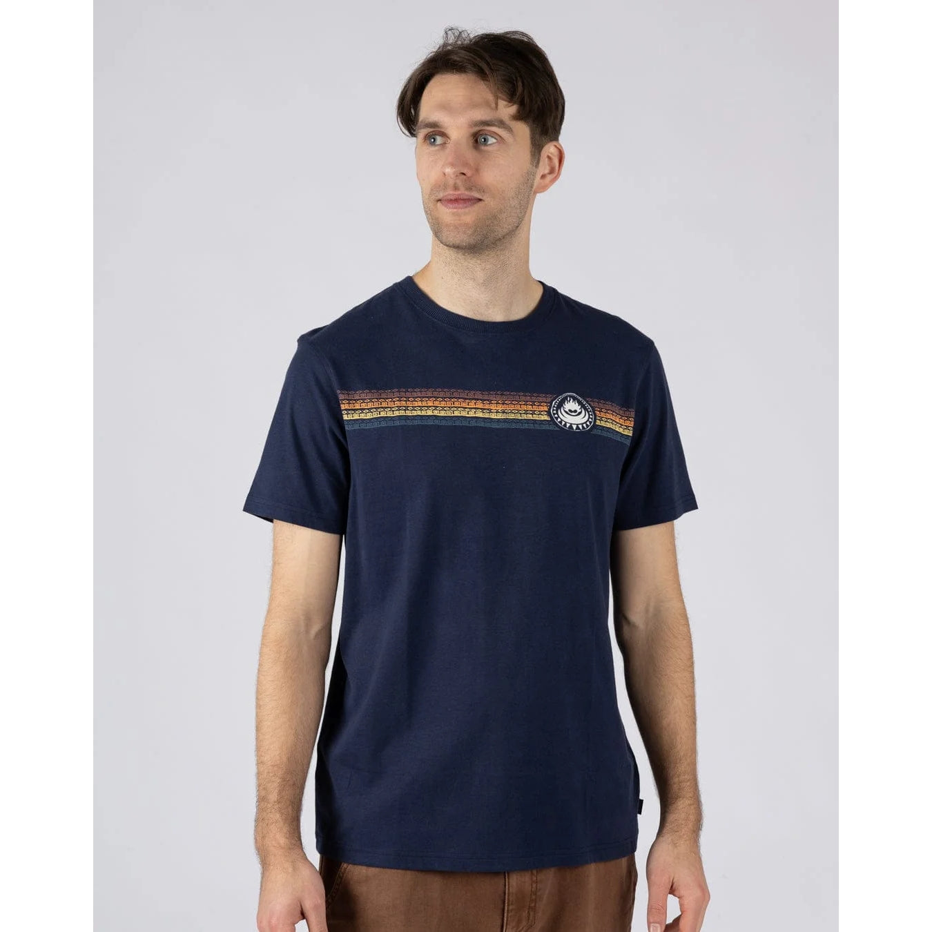 Front view of a man wearing a Saltrock short sleeve Tribal Stripe t-shirt in navy, with a multicoloured stripe print across the chest.
