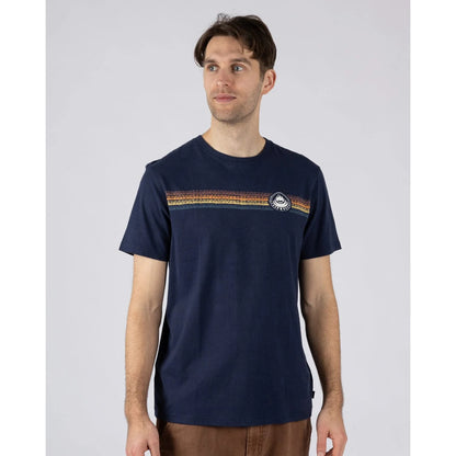 Front view of a man wearing a Saltrock short sleeve Tribal Stripe t-shirt in navy, with a multicoloured stripe print across the chest.