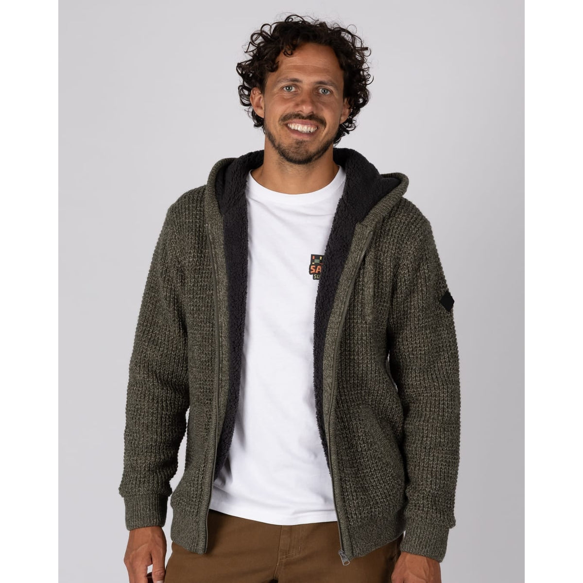 Front view of a man wearing a Saltrock dark green Markus knitted hoodie with a fluffy navy Borg lining, over a white t-shirt