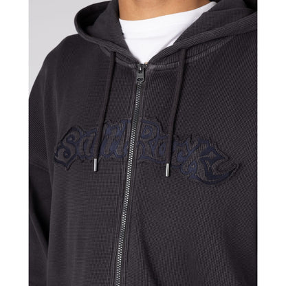 Close-up view of the chest logo applique on a Saltrock Heritage Logo oversized full zip hoodie in Dark Grey with a waffle texture.