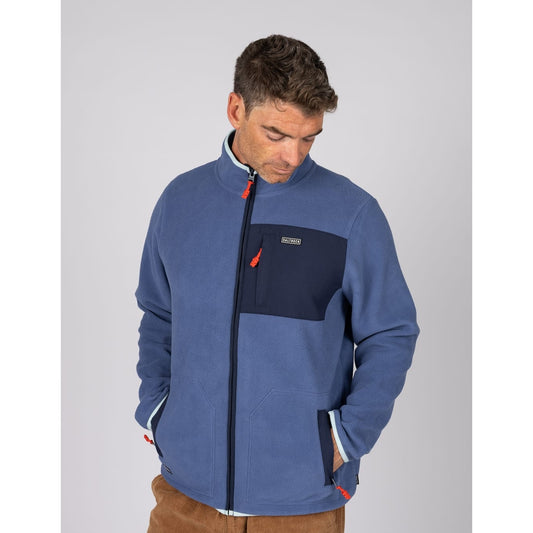 Front view of a man wearing a Saltrock full zip Leo fleece in blue, with contrasting navy, turquoise and red trim, tummy pockets and one zip pocket on the chest.