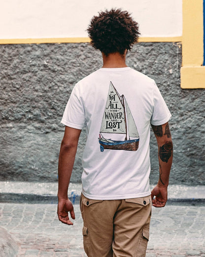 Back view of a man wearing a white Saltrock mens lost ships tee with a sailboat graphic and quote
