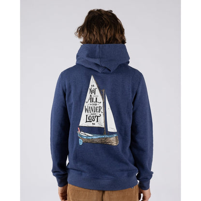 Main view of a man wearing a Saltrock Lost Ships pop hoodie in blue featuring a sail boat print with the quote "Not all who Wander are Lost"