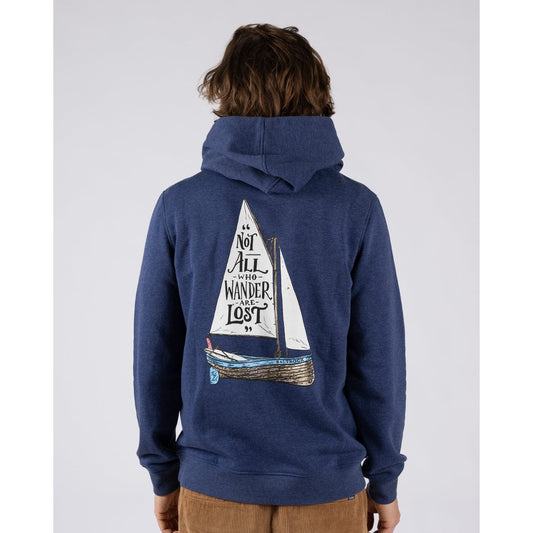 Main view of a man wearing a Saltrock Lost Ships pop hoodie in blue featuring a sail boat print with the quote "Not all who Wander are Lost"