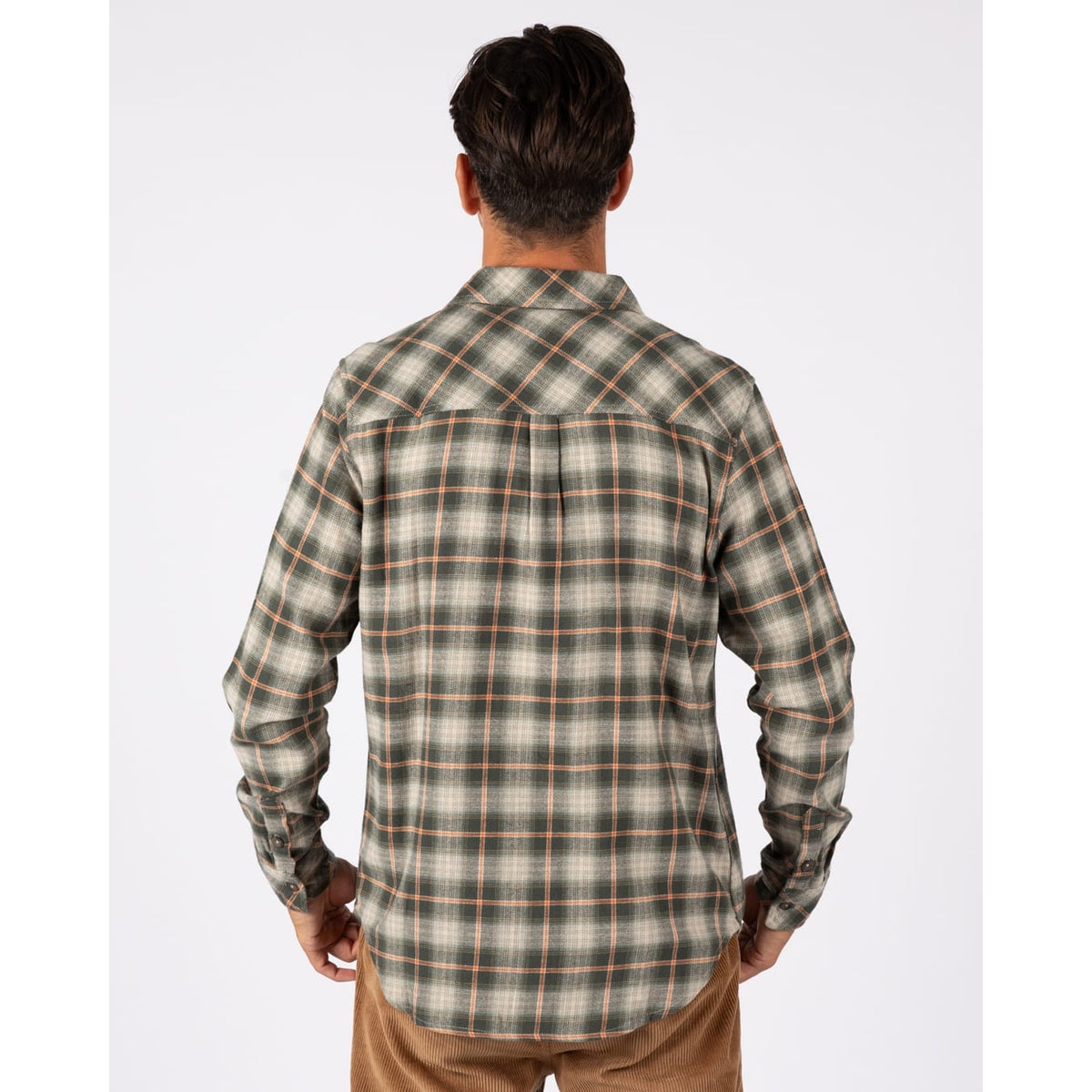 Back view of a man wearing a Saltrock long sleeve Miles flannel shirt in a green and orange check pattern.