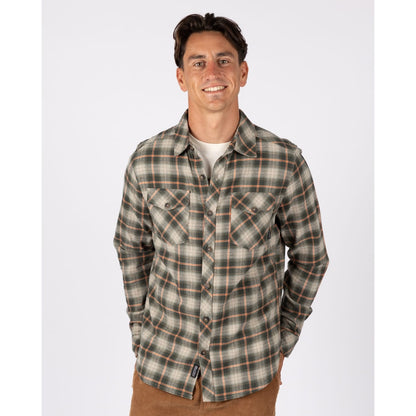 Front view of a man wearing a Saltrock long sleeve Miles flannel shirt in a green and orange check pattern.