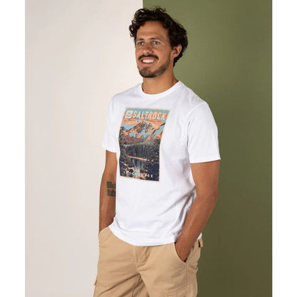 Man wearing a white Saltrock t-shirt with a graphic design, standing against a plain background