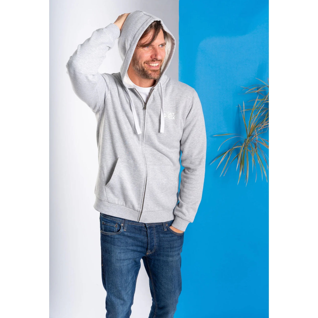 Man wearing a Saltrock mens Original faux fur lined zip hoodie in grey against a blue and white background