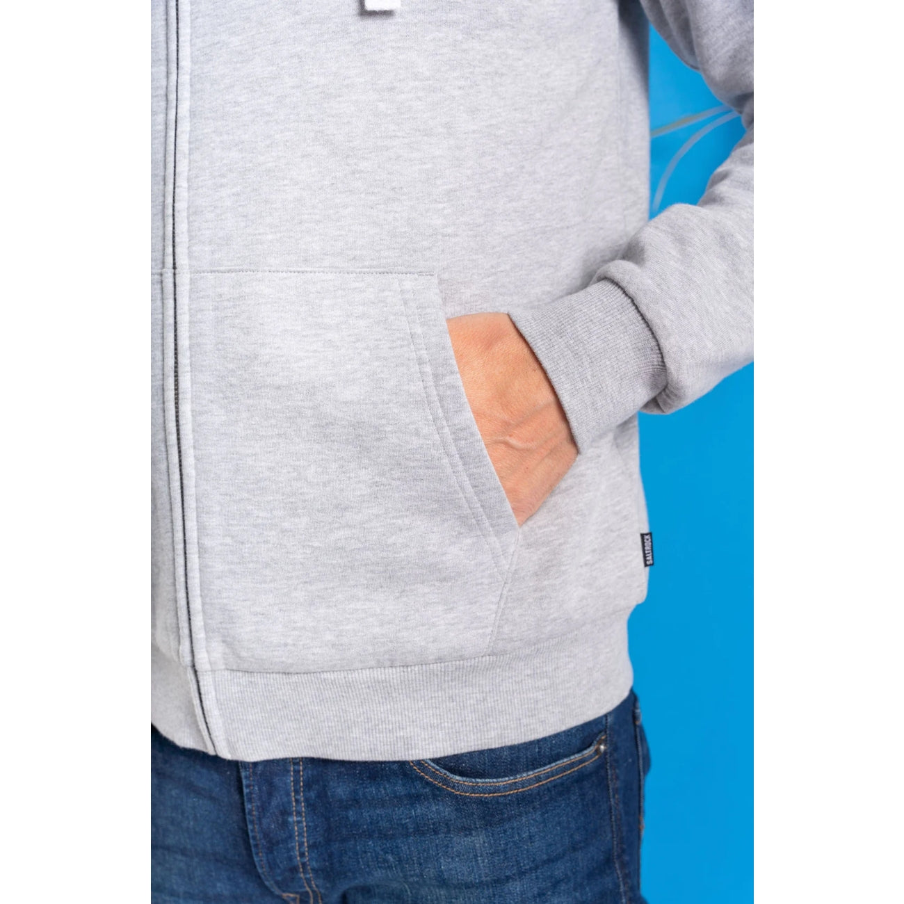 Grey mens Saltrock faux fur lined hoodie with a zipper and blue jeans on a blue background