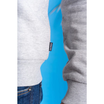 Close up of a mens Saltrock grey hoodie elasticated hem, cuff and small logo label on a blue background