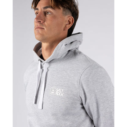 Man wearing a grey hoodie with 'Salt Rock' logo on a light gray background