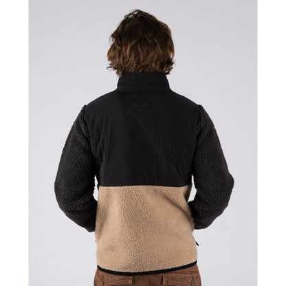 Back view of a man wearing a Saltrock Rafe zip fleece in black and beige with a colour block design.