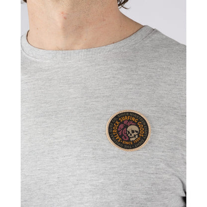 Close-up view of the front badge patch sewn on a Saltrock mens Trail Badge long sleeve t-shirt in grey