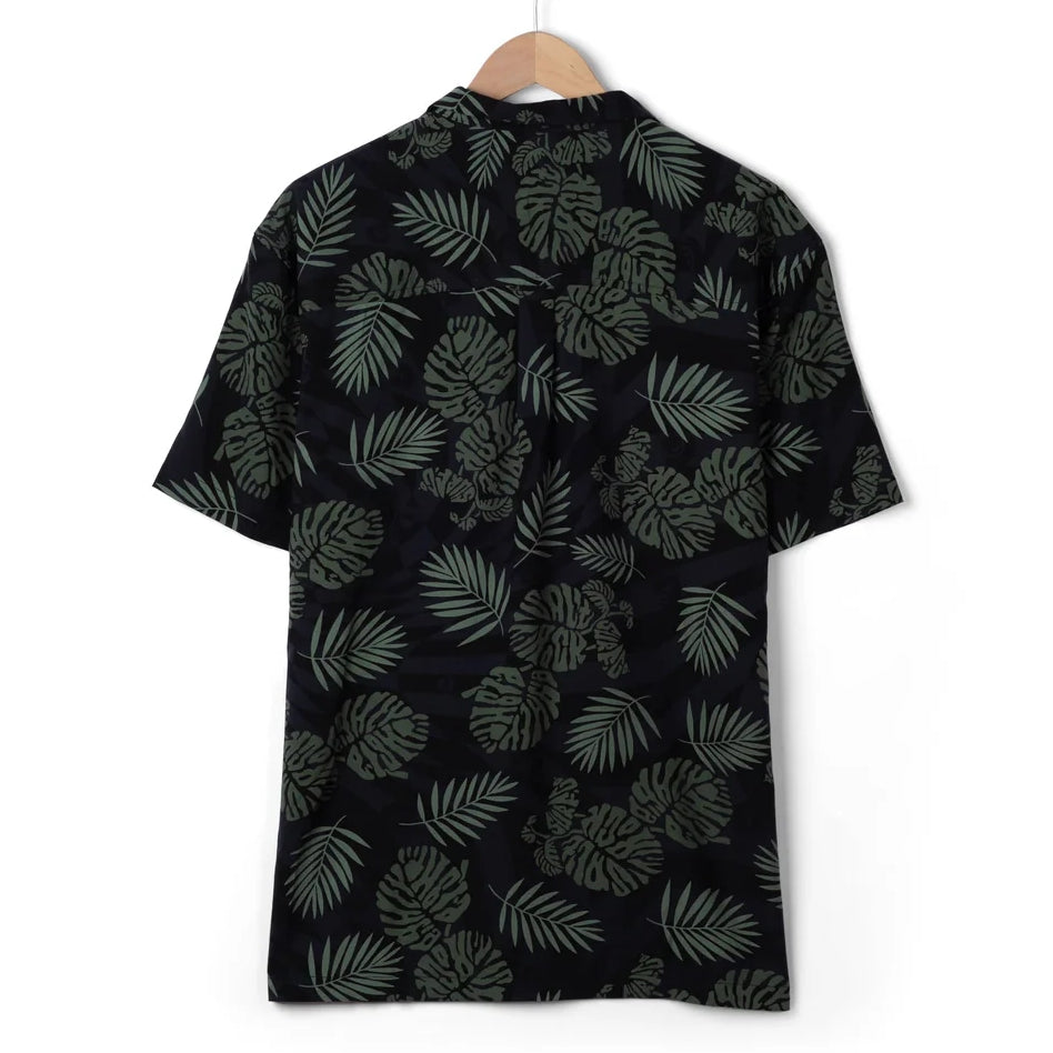 Back view of a mens Saltrock short sleeve Warp Surf Resort shirt in dark grey with a geometric and green tropical leaf print.