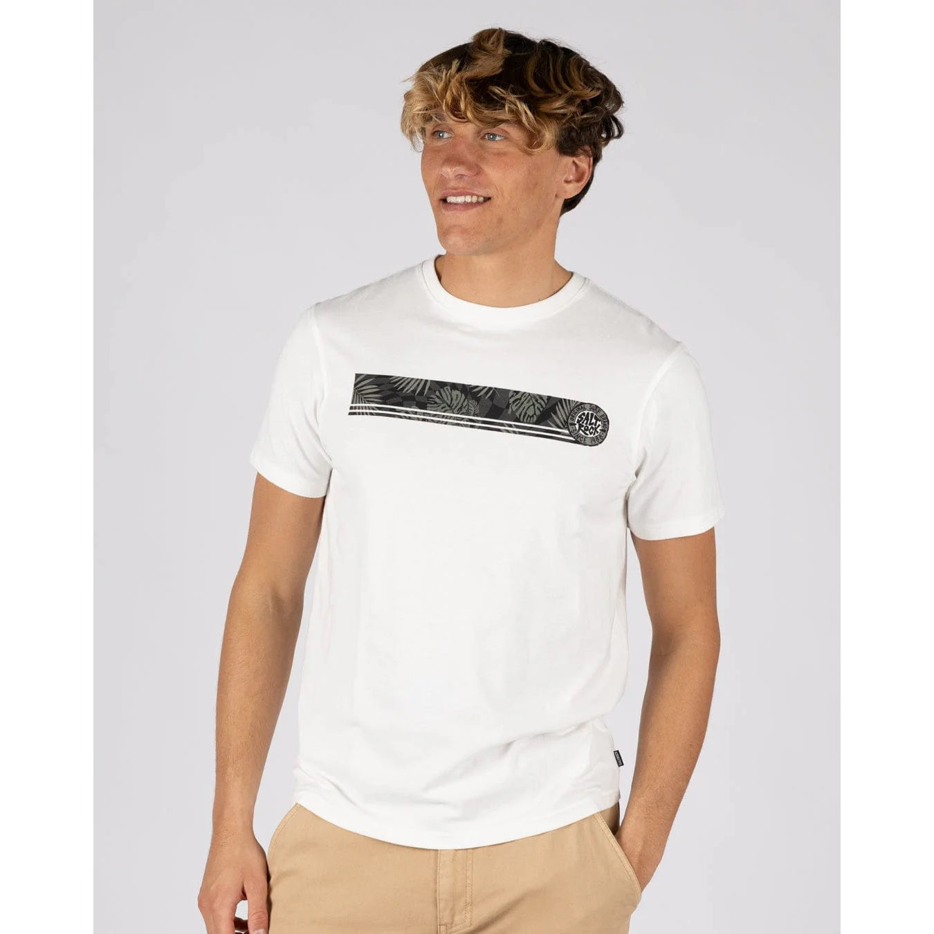 A man wearing a Saltrock short sleeve Warp Surf Stripe t-shirt in cream with grey stripe print across the chest