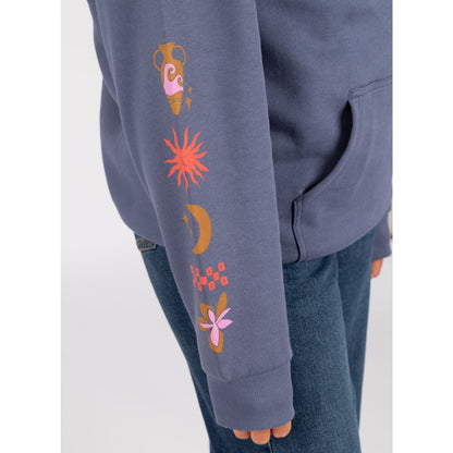 Close-up view off the sleeve of a womens Saltrock Athena hoodie in blue with a terracotta vase, sun, moon, check pattern and floral print along the sleeve.