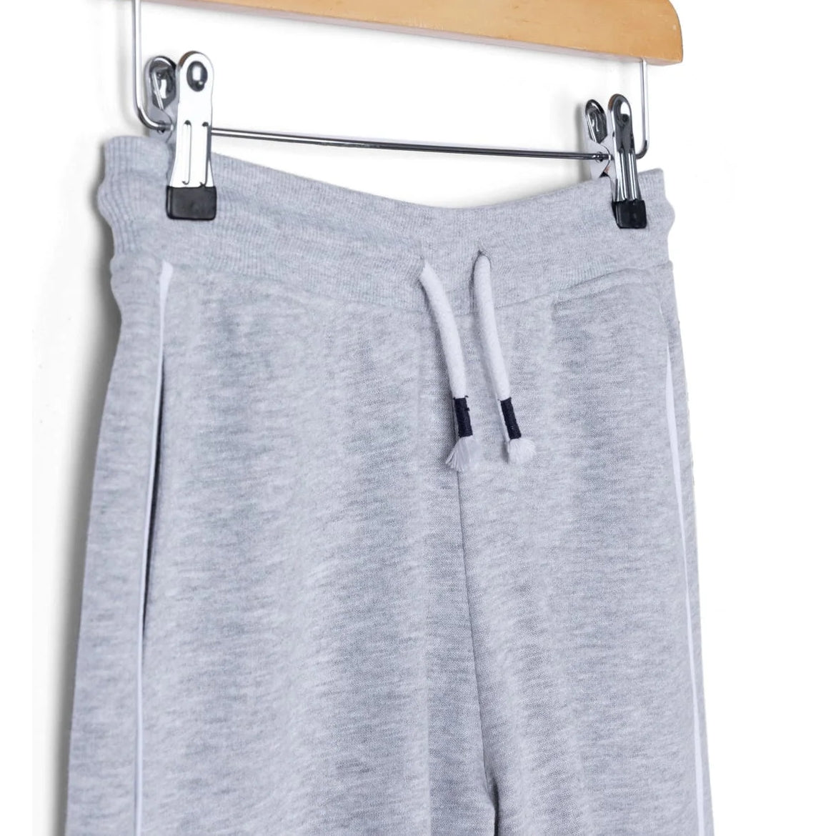 Close-up view of the elasticated drawstring waist on kids Saltrock Tok Corp jogger trousers in grey with hip pockets