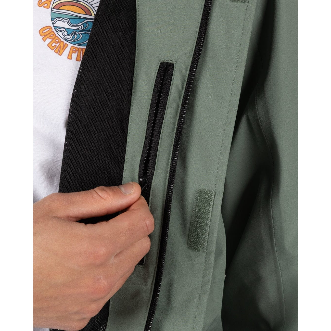 Close-up view of an internal zip pocket on a mens Saltrock Whistler II waterproof hooded jacket in light green
