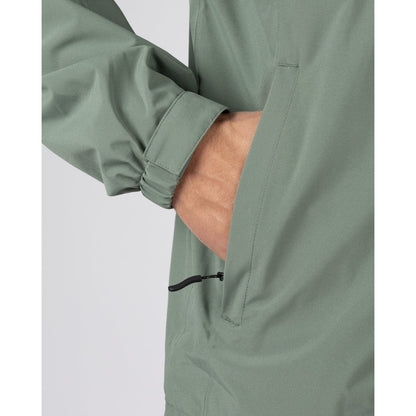 Close-up view of a tummy zip pocket on a mens Saltrock Whistler II waterproof hooded jacket in light green