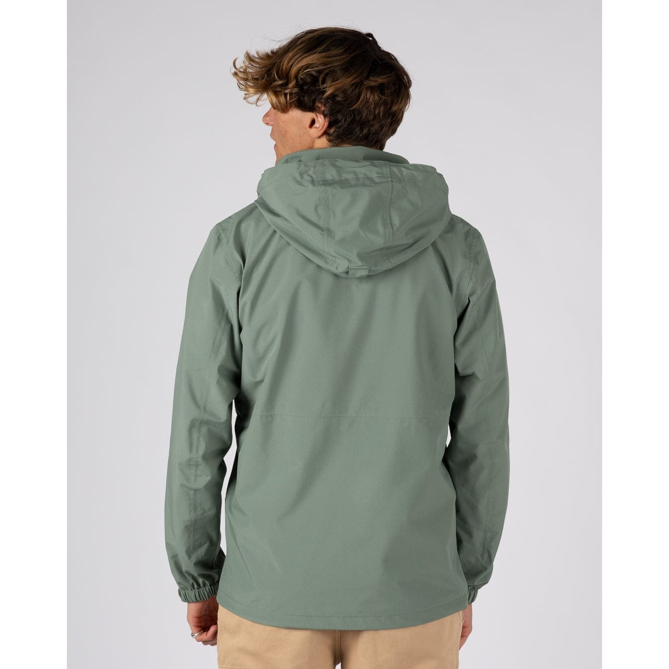 Back view of a man wearing a Saltrock Whistler II waterproof hooded jacket in light green