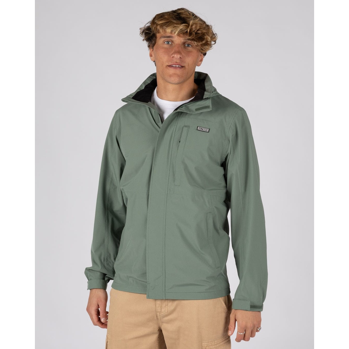Front view of a man wearing a Saltrock Whistler II waterproof jacket in light green