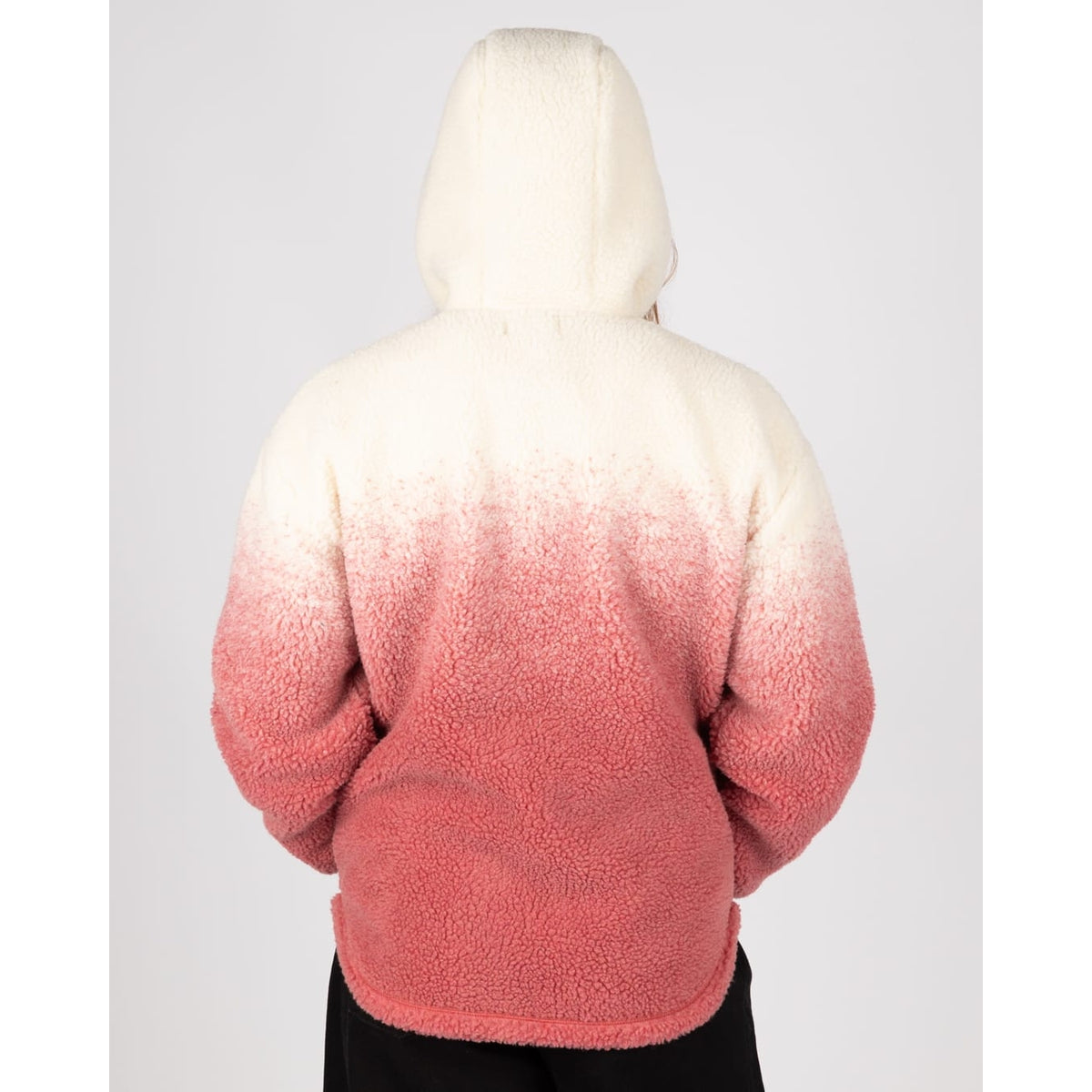 Back view of a woman wearing a Saltrock full zip hooded Alba sherpa fleece in a dip dye cream to pink design.