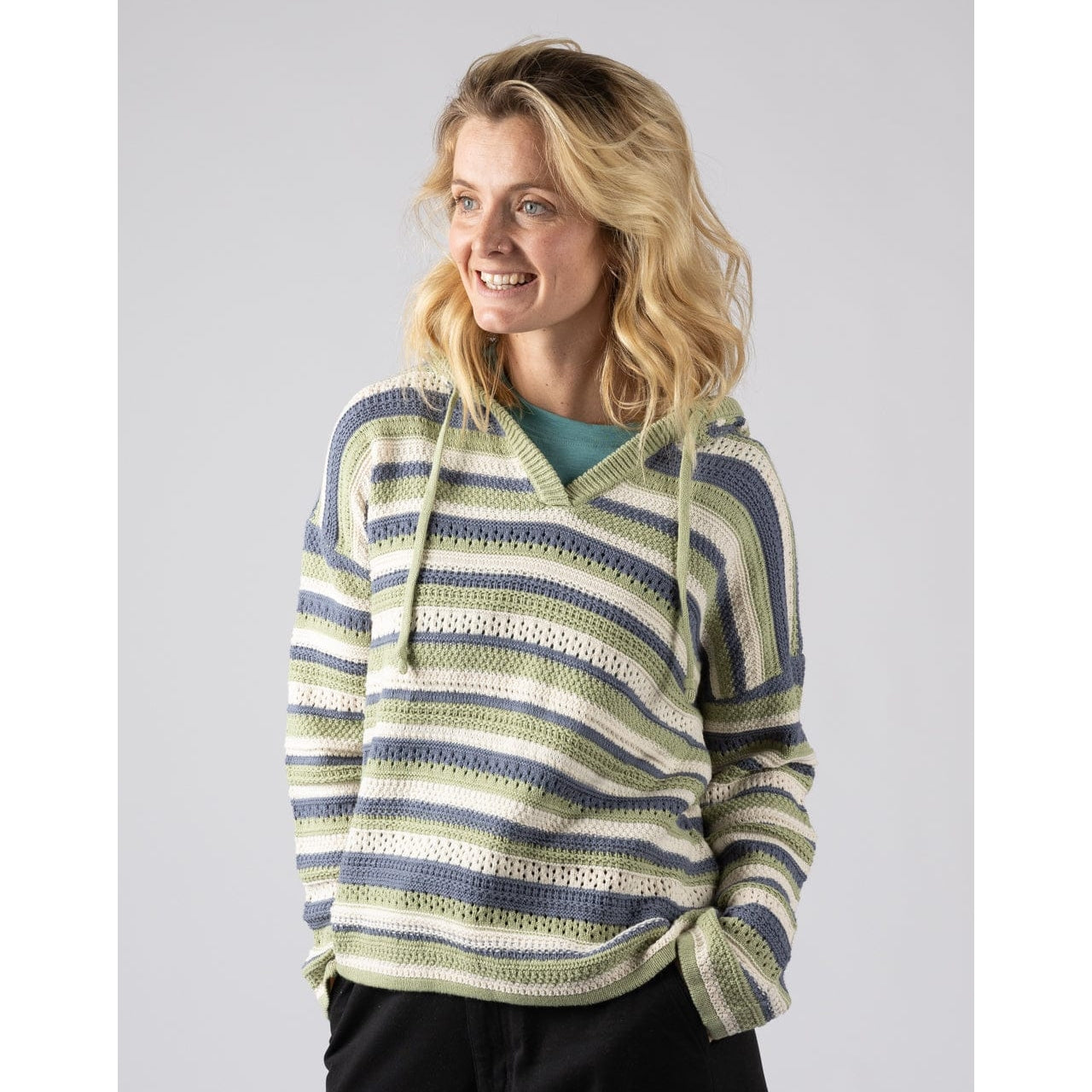 Front view of a woman wearing a green, blue and white striped Saltrock Aurelia knitted hoodie