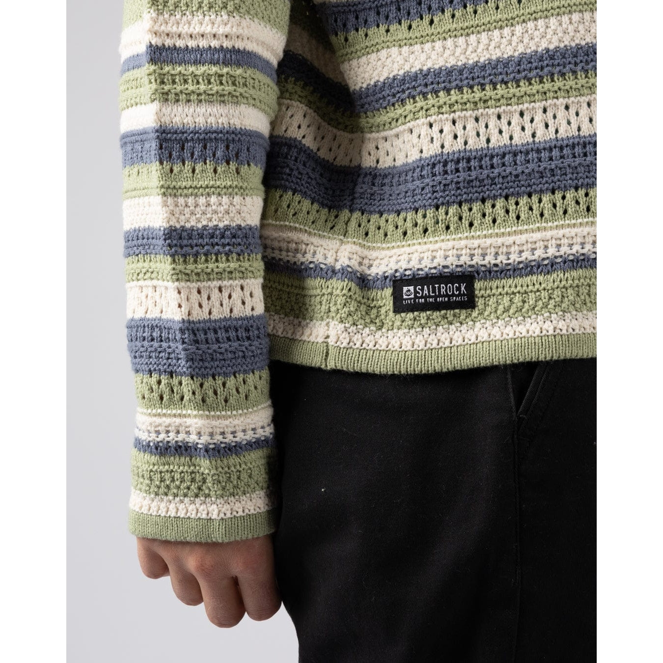Close-up of a womens Saltrock Aurelia green, blue and white striped knitted hoodie with a visible brand logo