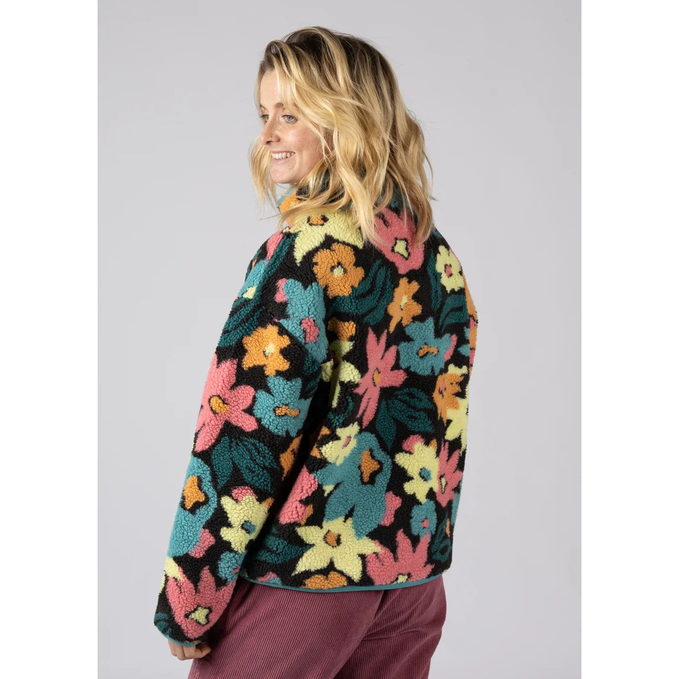 Back view of a woman wearing a Saltrock multicolour floral Holidaze sherpa fleece