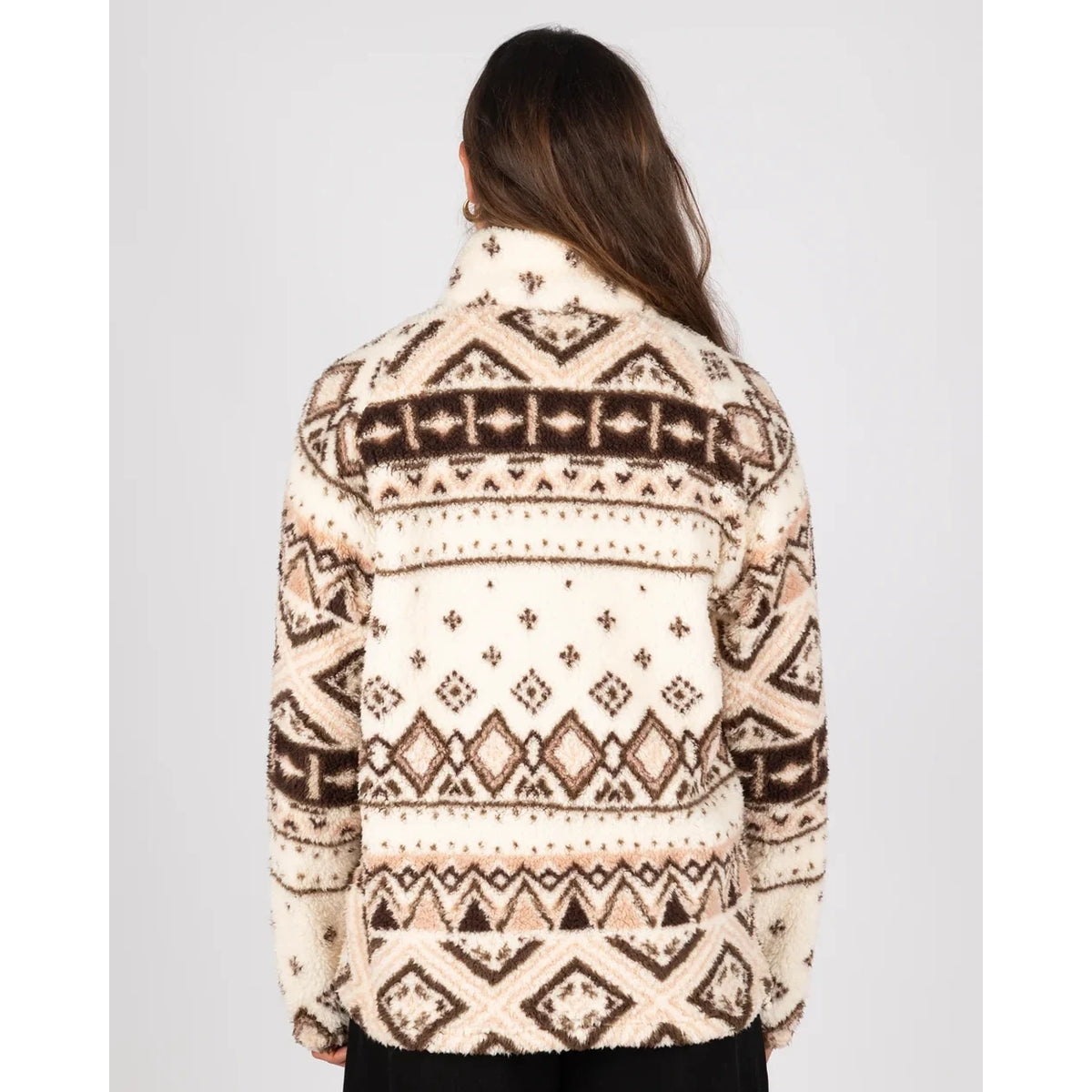 Back view of a woman wearing a Saltrock 1/4 zip Skylar fleece in cream with a brown geometric pattern